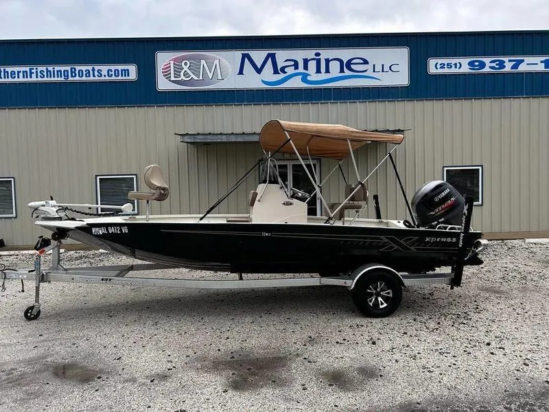 Slide: The Image of 2021 Xpress H20B boat with canopy on trailer, parked outside L&M Marine LLC. - 0