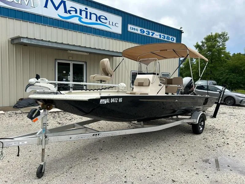 Slide: The Image of 2021 Xpress H20B boat on trailer outside marine dealership. - 1