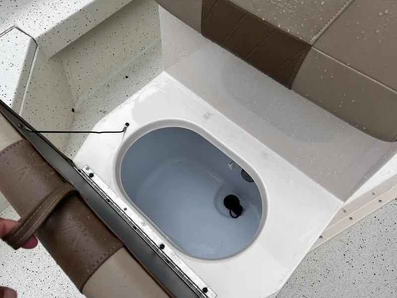 Slide: The Image of 2021 Xpress H20B boat seat with built-in storage compartment, open view. - 13