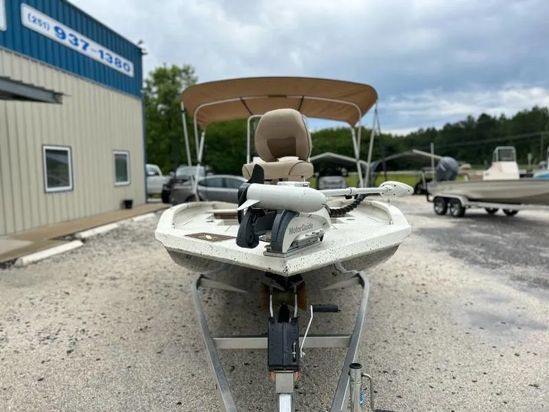 Slide: The Image of 2021 Xpress H20B boat with canopy on trailer, parked outside dealership. - 2