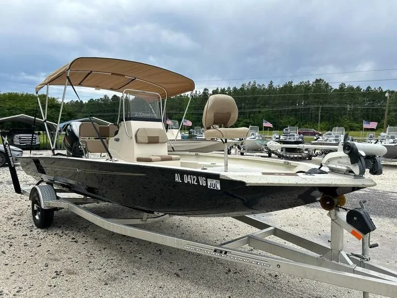 Slide: The Image of 2021 Xpress H20B boat on trailer with canopy, parked outdoors. - 3