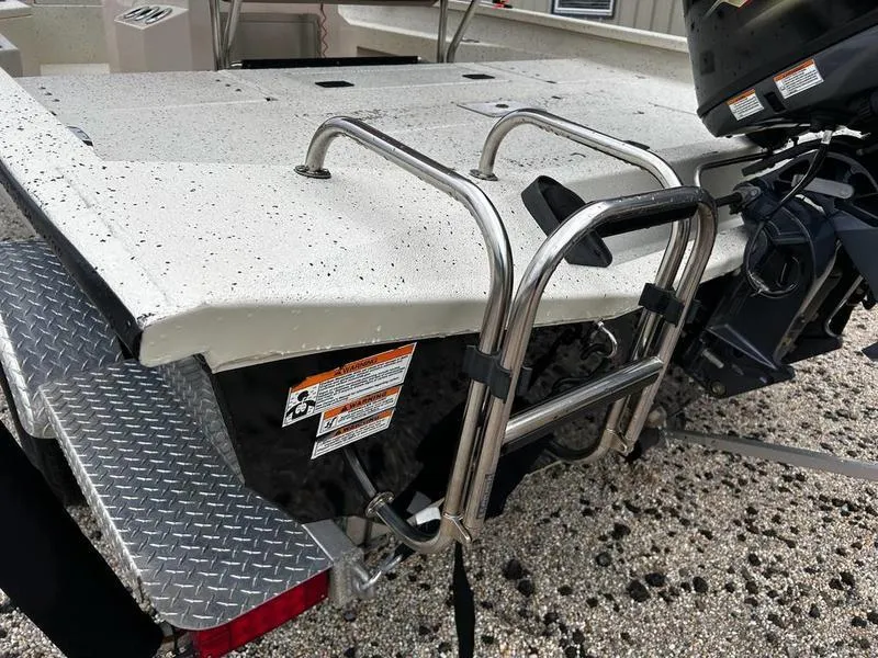 Slide: The Image of 2021 Xpress H20B boat with ladder and motor, rear view. - 7