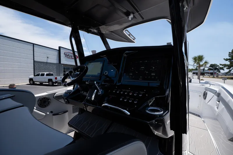 Slide: The Image of 2023 Sunsation 32 CCX boat cockpit with modern controls and steering wheel. - 16