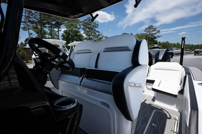 Slide: The Image of 2023 Sunsation 32 CCX boat interior with sleek seating and modern steering wheel. - 18