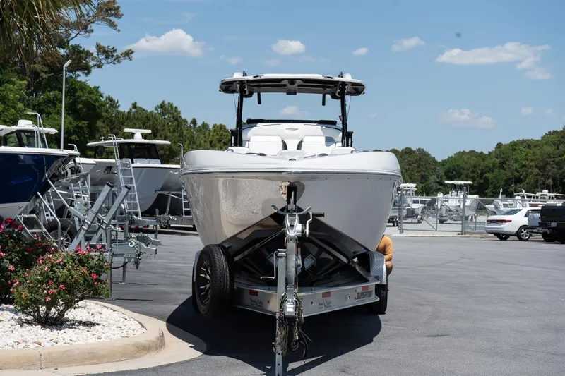 Slide: The Image of 2023 Sunsation 32 CCX boat on trailer in sunny outdoor dealership. - 2