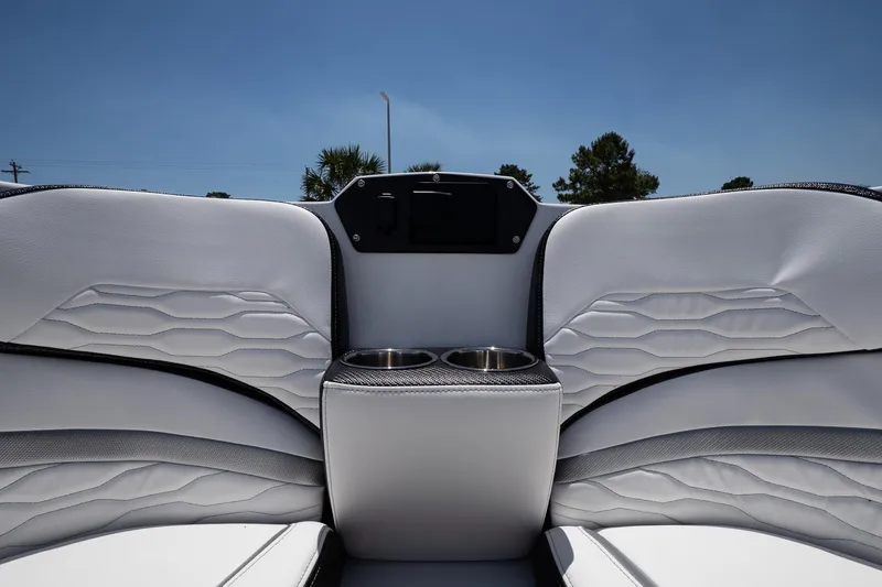 Slide: The Image of 2023 Sunsation 32 CCX boat interior with white seating and cup holders. - 23