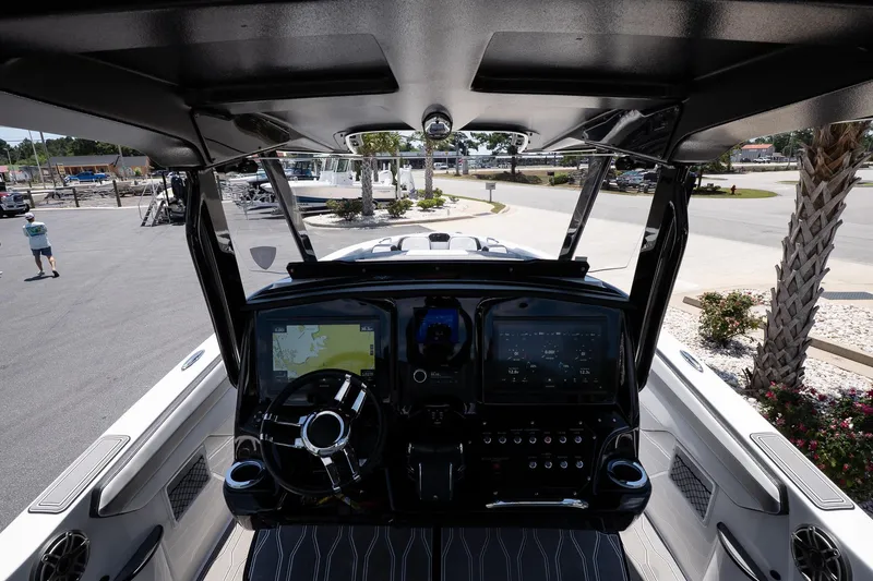 Slide: The Image of 2023 Sunsation 32 CCX boat cockpit with modern navigation system and steering wheel. - 24