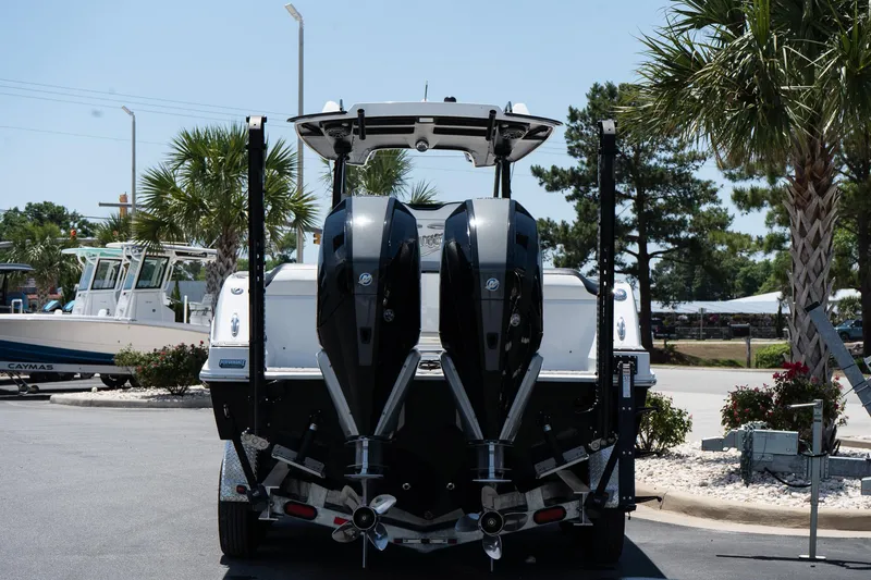 Slide: The Image of 2023 Sunsation 32 CCX boat with dual outboard motors, parked on a trailer. - 4