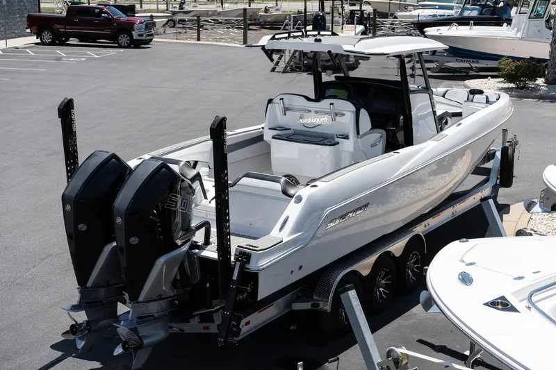 Slide: The Image of 2023 Sunsation 32 CCX boat with dual engines on a trailer in a marina. - 8