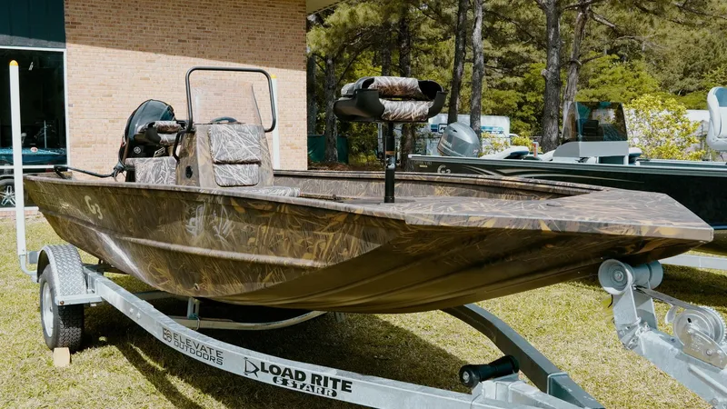 Slide: The Image of 2025 G3 18CC boat on Load Rite trailer, parked on grass. - 1