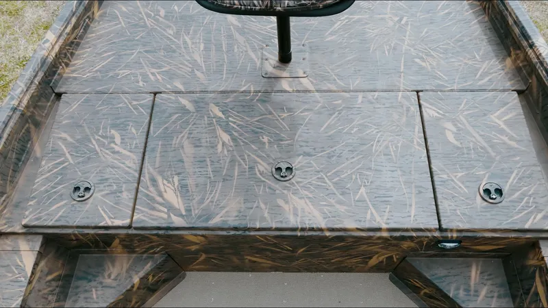 Slide: The Image of 2025 G3 18CC boat deck with camo pattern and storage compartments. - 11
