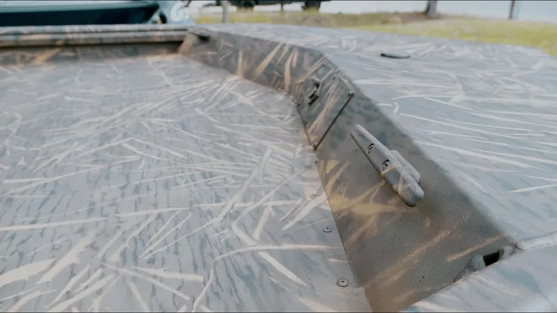 Slide: The Image of 2025 G3 18CC boat with camouflage pattern, featuring a textured deck and mounted accessories. - 14