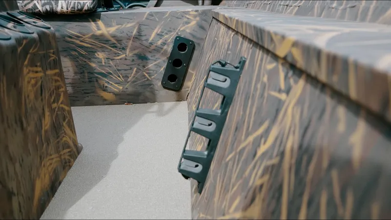 Slide: The Image of 2025 G3 18CC boat interior with camouflage design and utility features. - 4