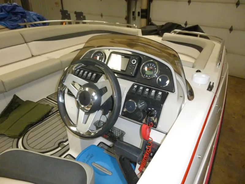 Slide: The Image of 2018 Starcraft 211 MDX boat interior with steering wheel and control panel. - 1
