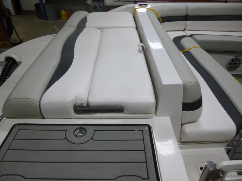 Slide: The Image of 2018 Starcraft 211 MDX boat interior with white and gray cushioned seating. - 2