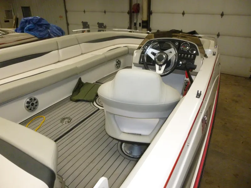 Slide: The Image of 2018 Starcraft 211 MDX boat interior with steering wheel and seating. - 3