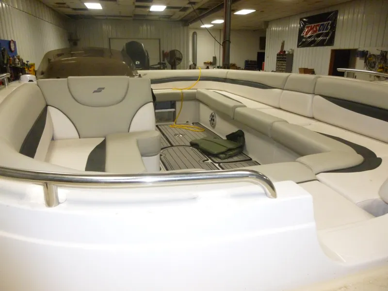 Slide: The Image of 2018 Starcraft 211 MDX boat interior with spacious seating in a well-lit garage. - 4