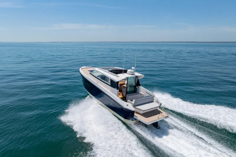 Slide: The Image of 2023 Delta Powerboats 33 Coupe cruising on open water, showcasing sleek design and performance. - 10
