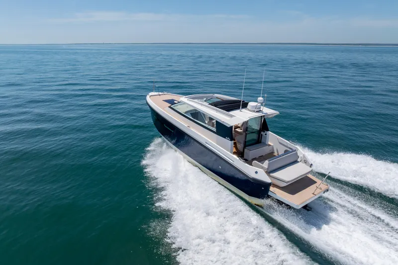 Slide: The Image of 2023 Delta Powerboats 33 Coupe cruising on open water, showcasing sleek design and performance. - 11