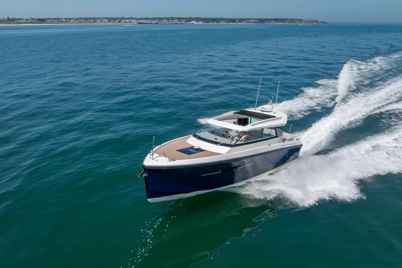 Slide: The Image of 2023 Delta Powerboats 33 Coupe cruising on open water. - 13