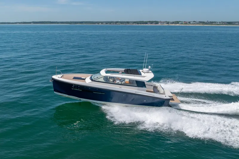 Slide: The Image of 2023 Delta Powerboats 33 Coupe cruising on open water, showcasing sleek design and performance. - 15