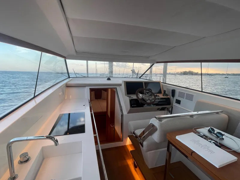 Slide: The Image of Interior of 2023 Delta Powerboats 33 Coupe with modern helm and sea view. - 17