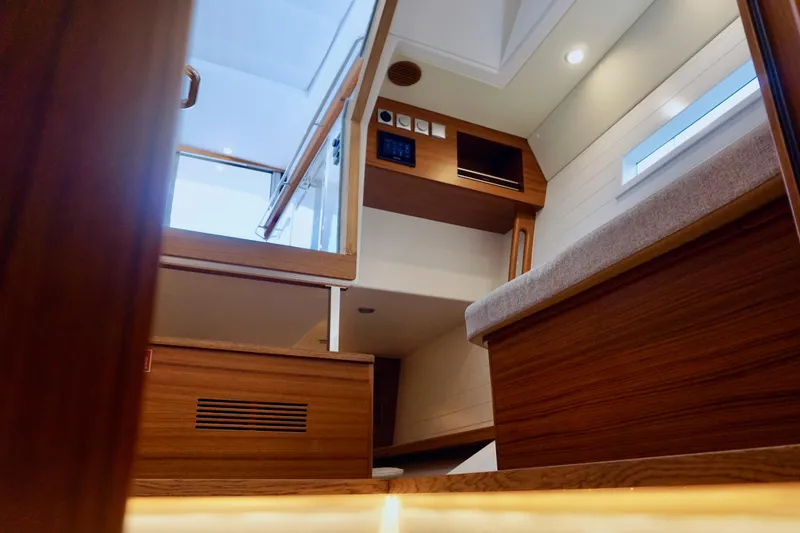Slide: The Image of Interior of 2023 Delta Powerboats 33 Coupe, featuring modern wood finishes and sleek design. - 21