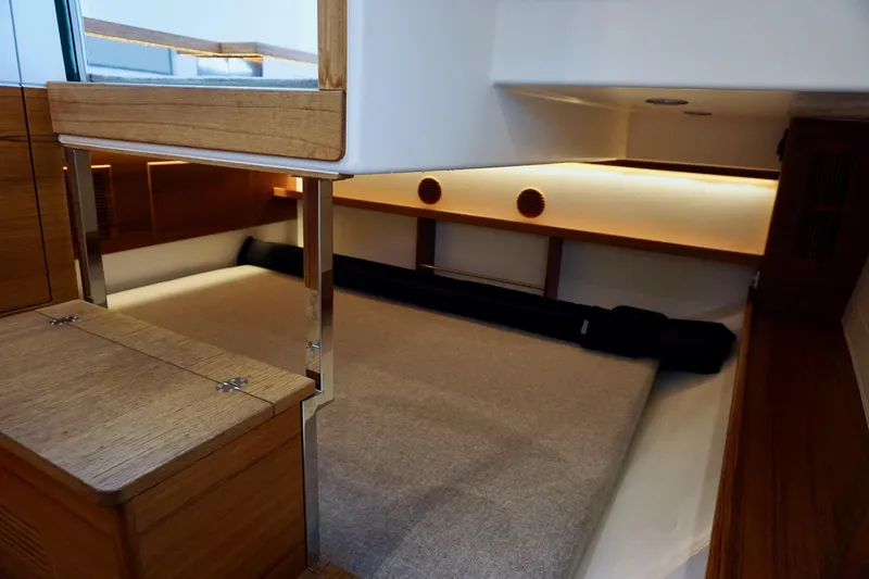 Slide: The Image of Interior cabin of 2023 Delta Powerboats 33 Coupe with modern wood finish. - 24