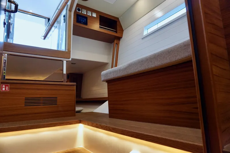 Slide: The Image of Interior of 2023 Delta Powerboats 33 Coupe, featuring wooden finishes and modern design. - 26