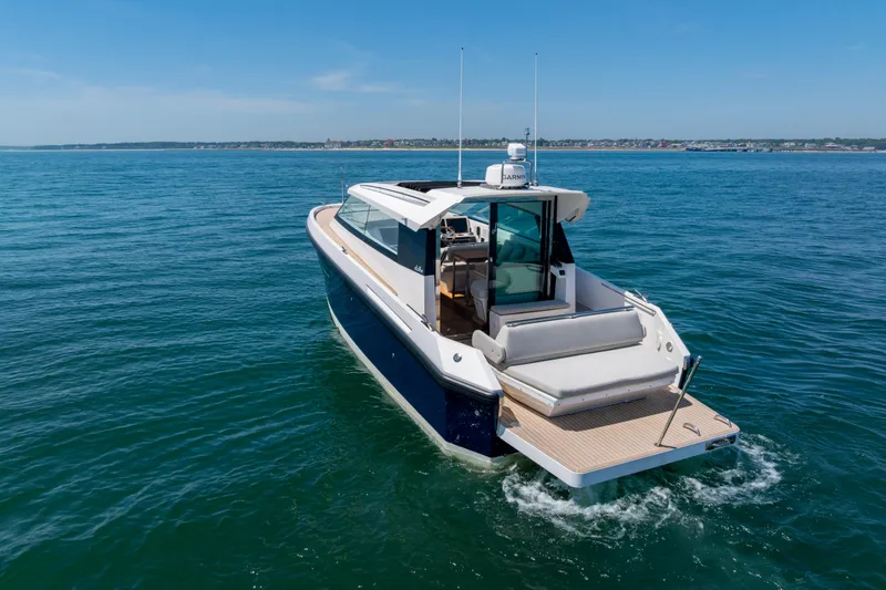 Slide: The Image of 2023 Delta Powerboats 33 Coupe cruising on open water. - 3