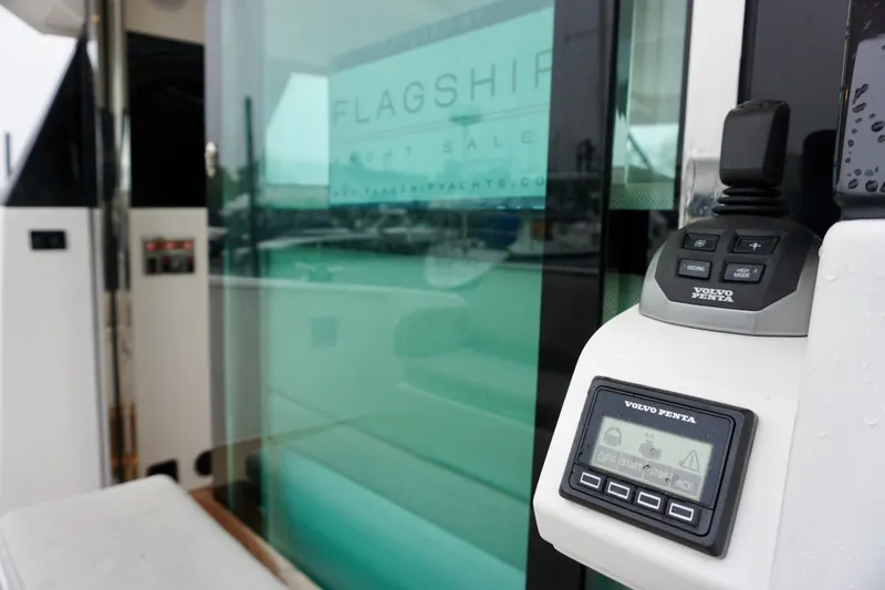 Slide: The Image of 2023 Delta Powerboats 33 Coupe with Volvo Penta control panel, docked at marina. - 32