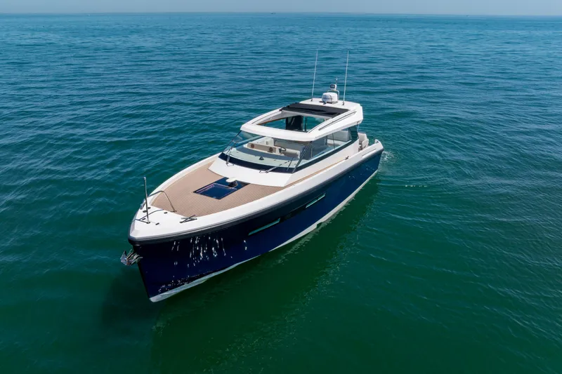 Slide: The Image of 2023 Delta Powerboats 33 Coupe cruising on open water. - 35