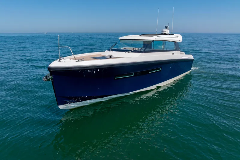 Slide: The Image of 2023 Delta Powerboats 33 Coupe cruising on open water. - 36