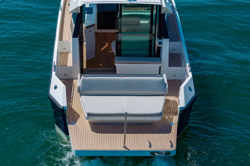 Slide: The Image of 2023 Delta Powerboats 33 Coupe, rear view on water, showcasing deck and seating. - 7