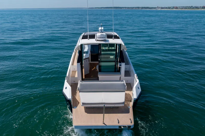 Slide: The Image of 2023 Delta Powerboats 33 Coupe cruising on open water, rear view. - 8