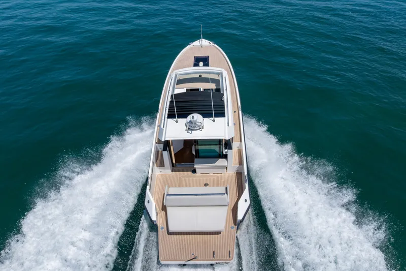 Slide: The Image of 2023 Delta Powerboats 33 Coupe cruising on open water, aerial view. - 9