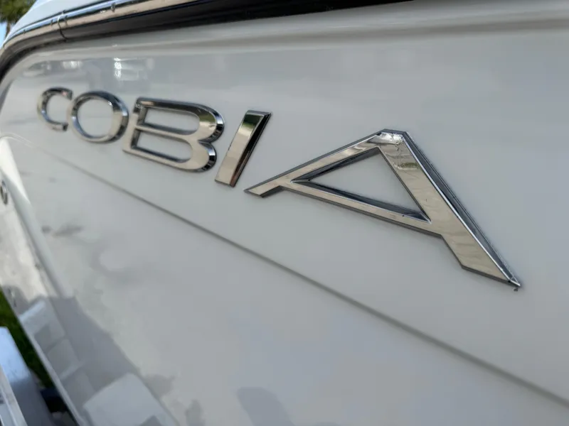 Slide: The Image of Cobia 220 Center Console 2020 boat logo on white hull. - 11