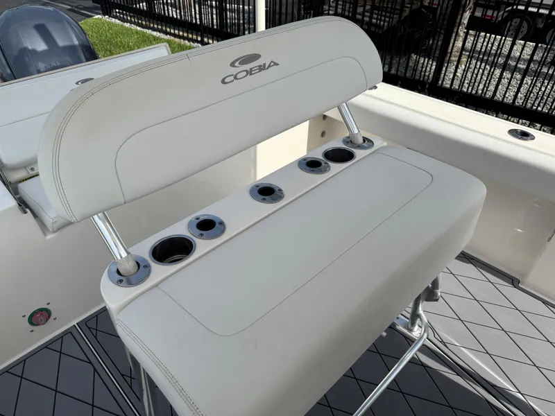 Slide: The Image of 2020 Cobia 220 Center Console boat seating with integrated cup holders. - 13