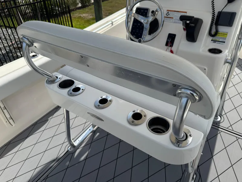 Slide: The Image of 2020 Cobia 220 Center Console boat interior with rod holders and steering console. - 15