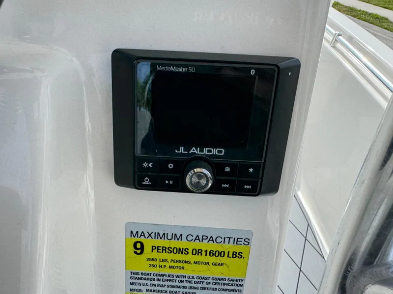 Slide: The Image of Control panel and capacity label on 2020 Cobia 220 Center Console boat. - 17