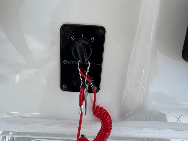 Slide: The Image of Yamaha ignition switch with safety lanyard on 2020 Cobia 220 Center Console boat. - 20