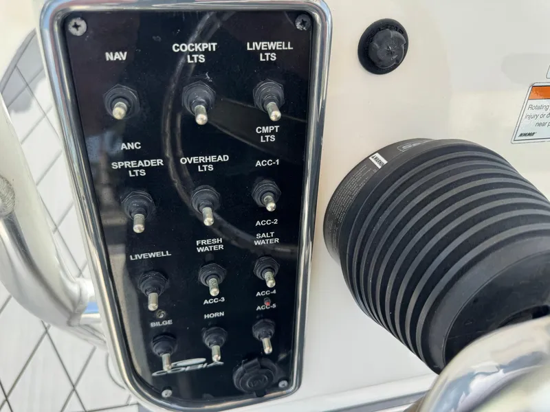 Slide: The Image of Control panel of a 2020 Cobia 220 Center Console boat with various switches. - 21
