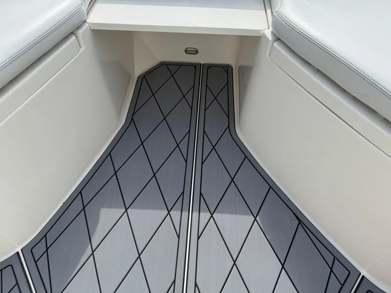 Slide: The Image of 2020 Cobia 220 Center Console boat interior with diamond-patterned flooring. - 26