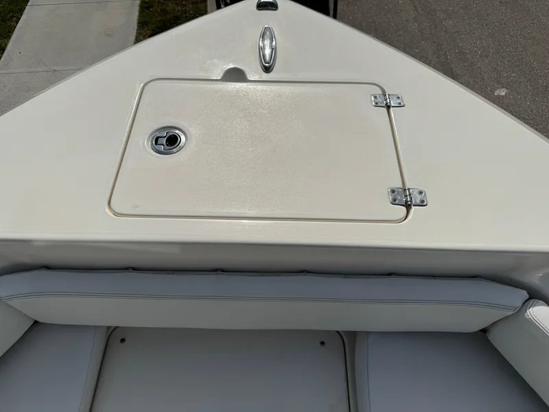 Slide: The Image of 2020 Cobia 220 Center Console boat bow with storage compartment and seating. - 28