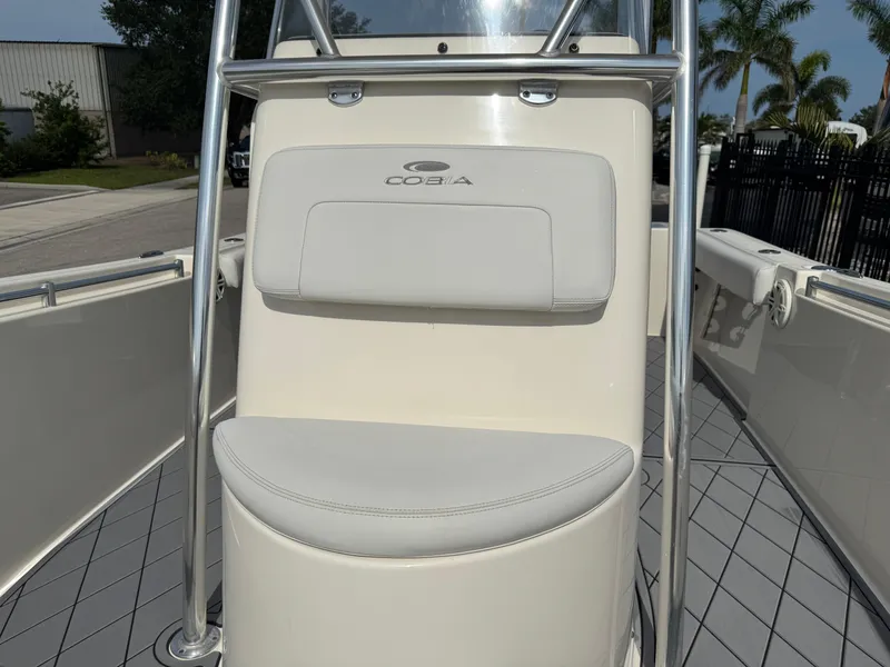 Slide: The Image of 2020 Cobia 220 Center Console boat interior with cushioned seating and stainless steel frame. - 30