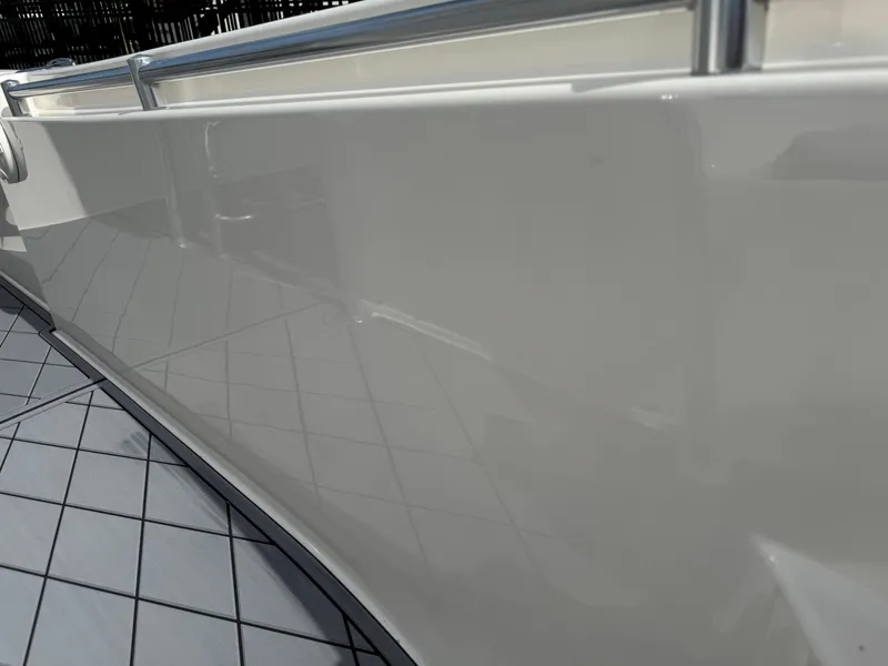Slide: The Image of 2020 Cobia 220 Center Console boat, side view, glossy white finish. - 31