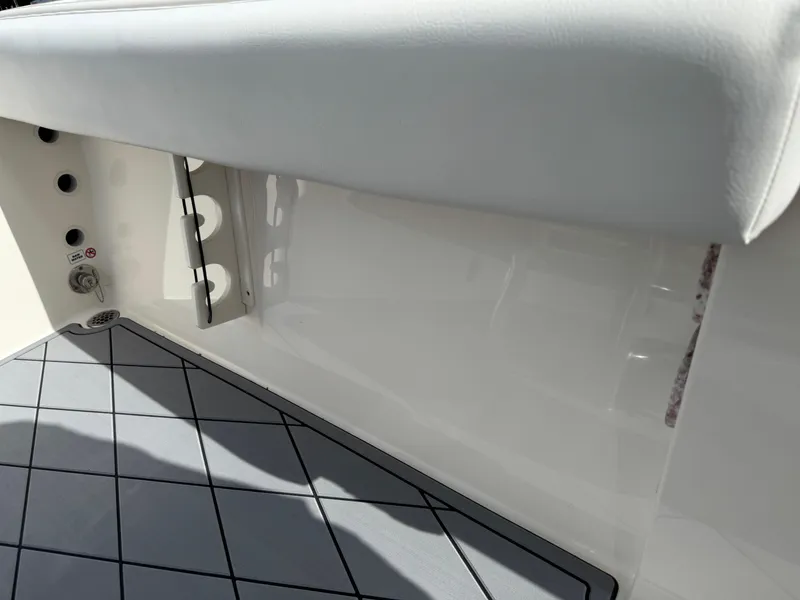 Slide: The Image of 2020 Cobia 220 Center Console interior detail with cushioned seating and non-slip flooring. - 32