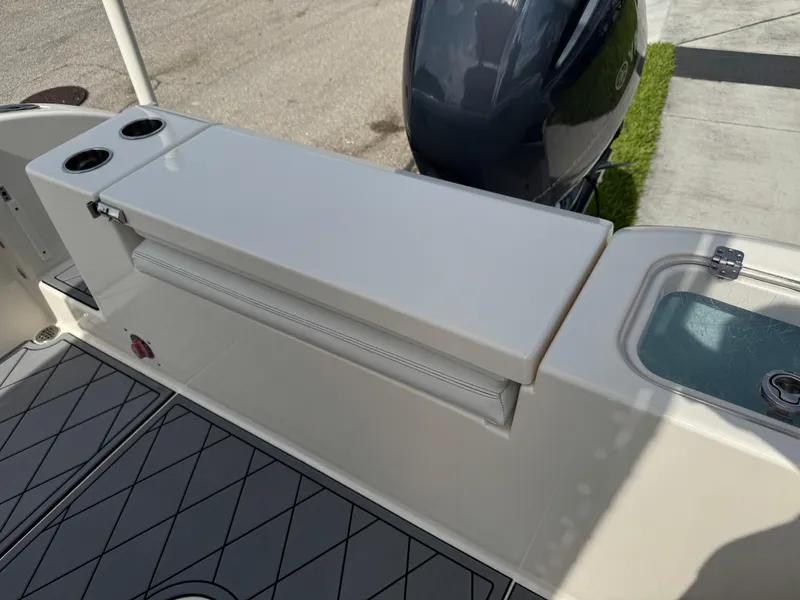 Slide: The Image of 2020 Cobia 220 Center Console boat with seating and storage area. - 34