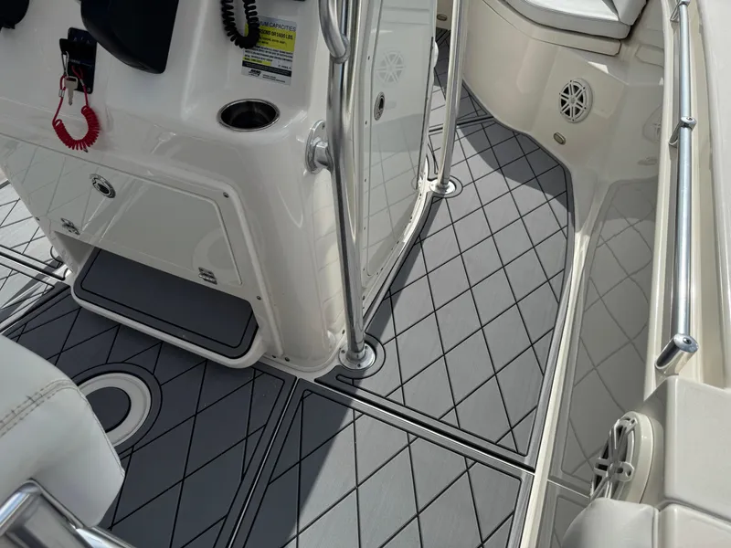 Slide: The Image of 2020 Cobia 220 Center Console boat interior with gray diamond-patterned flooring. - 37