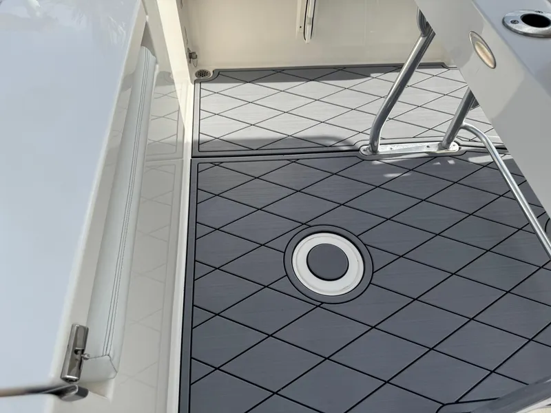 Slide: The Image of Cobia 220 Center Console 2020 boat deck with diamond-patterned flooring. - 38